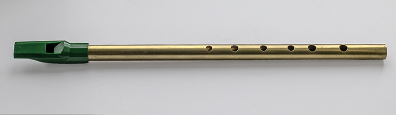 Brass coloured tin whistle with a green mouth piece